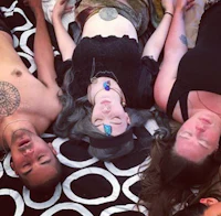 a group of people laying down on a blanket