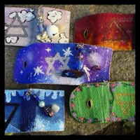 a group of different colored pouches with different symbols on them