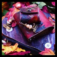 a leather book with buttons and leaves on it