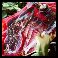 a painting of a red ax lying on the ground