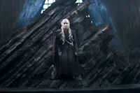 game of thrones - a woman standing on top of a large pile of wood