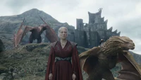 game of thrones - dragons and a woman standing in front of a castle