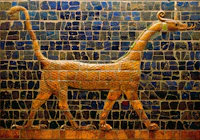 a statue of a golden dog on a blue tiled wall